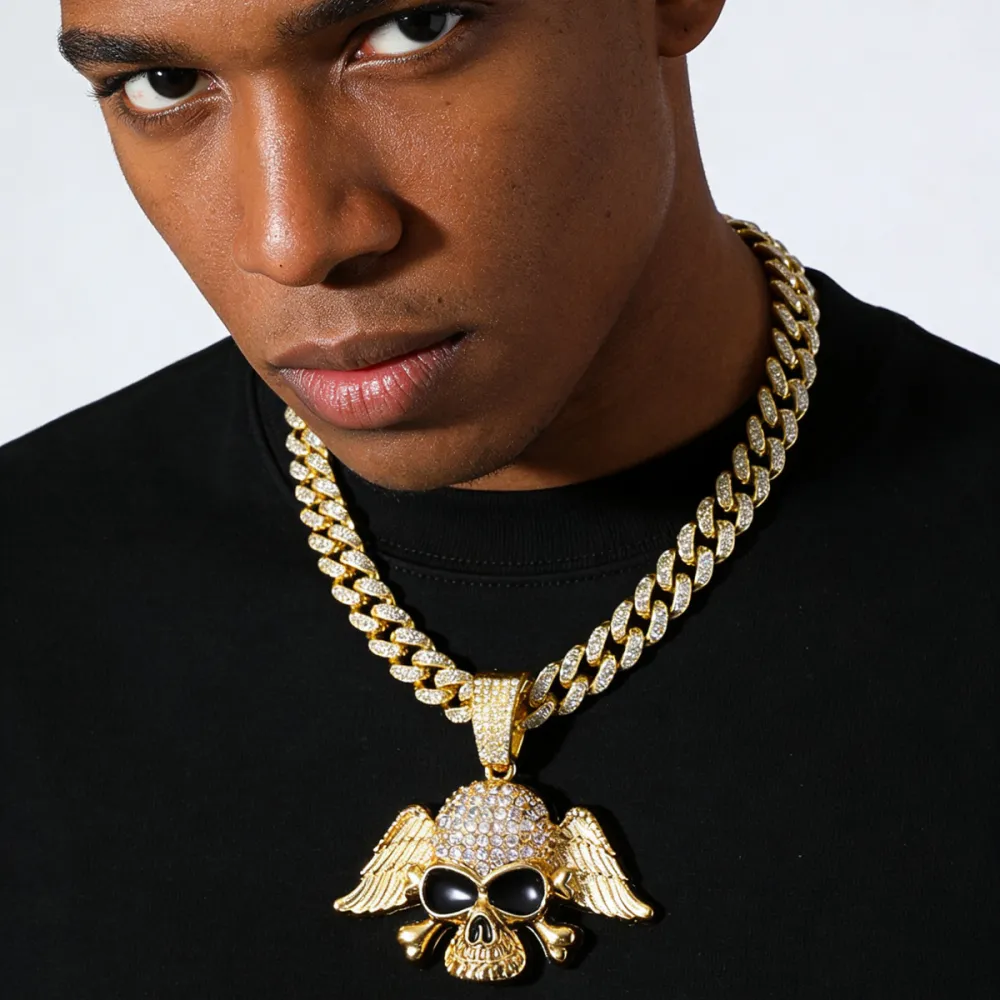 💀 NOT MADE TO BLEND IN. 🔥  Turn heads the second you walk in.  This iced-out Cuban chain features a bold winged skull pendant, packed with eye-catching shine and serious street attitude. Whether you choose Gold or Silver, this piece instantly upgrades y