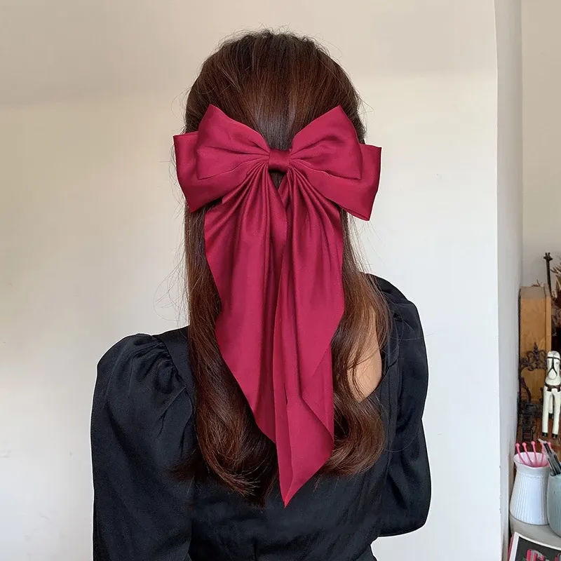 Oversized Satin Bow Hair Clip adds an elegant, feminine finish to everyday hairstyles in seconds. The flowing long-tail design looks beautiful with ponytails, half-up styles, curls and more.