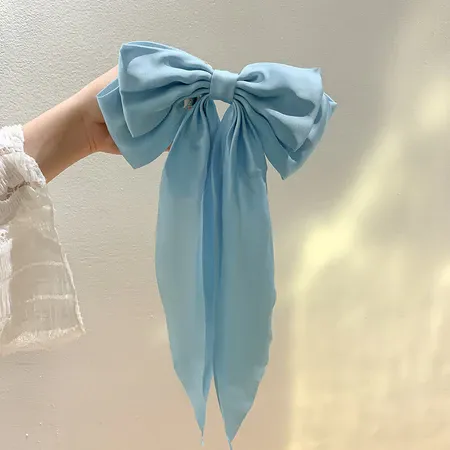 Oversized Satin Bow Hair Clip adds an elegant, feminine finish to everyday hairstyles in seconds. The flowing long-tail design looks beautiful with ponytails, half-up styles, curls and more.