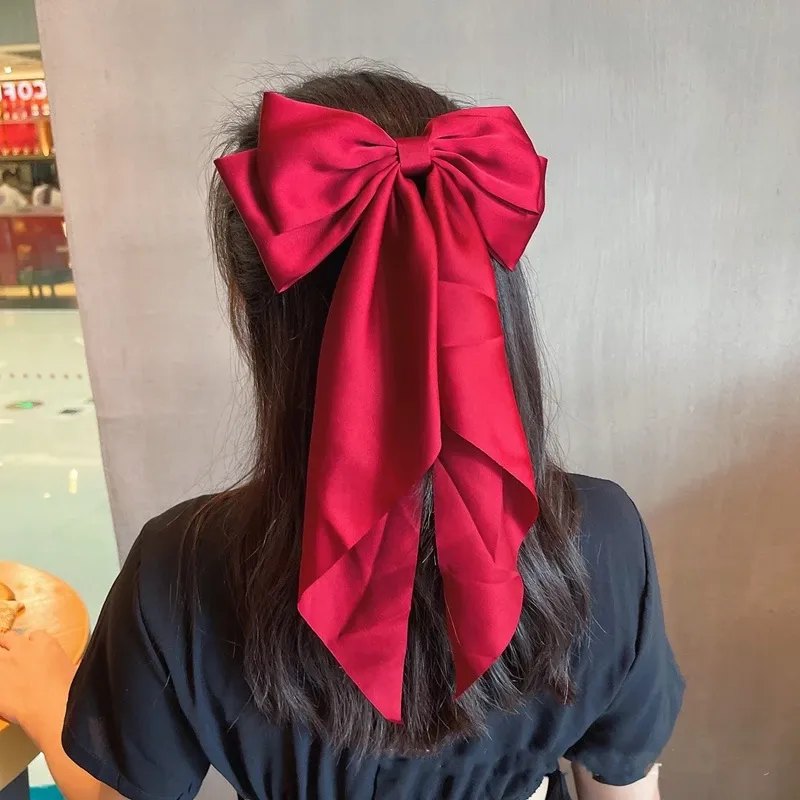 Oversized Satin Bow Hair Clip adds an elegant, feminine finish to everyday hairstyles in seconds. The flowing long-tail design looks beautiful with ponytails, half-up styles, curls and more.