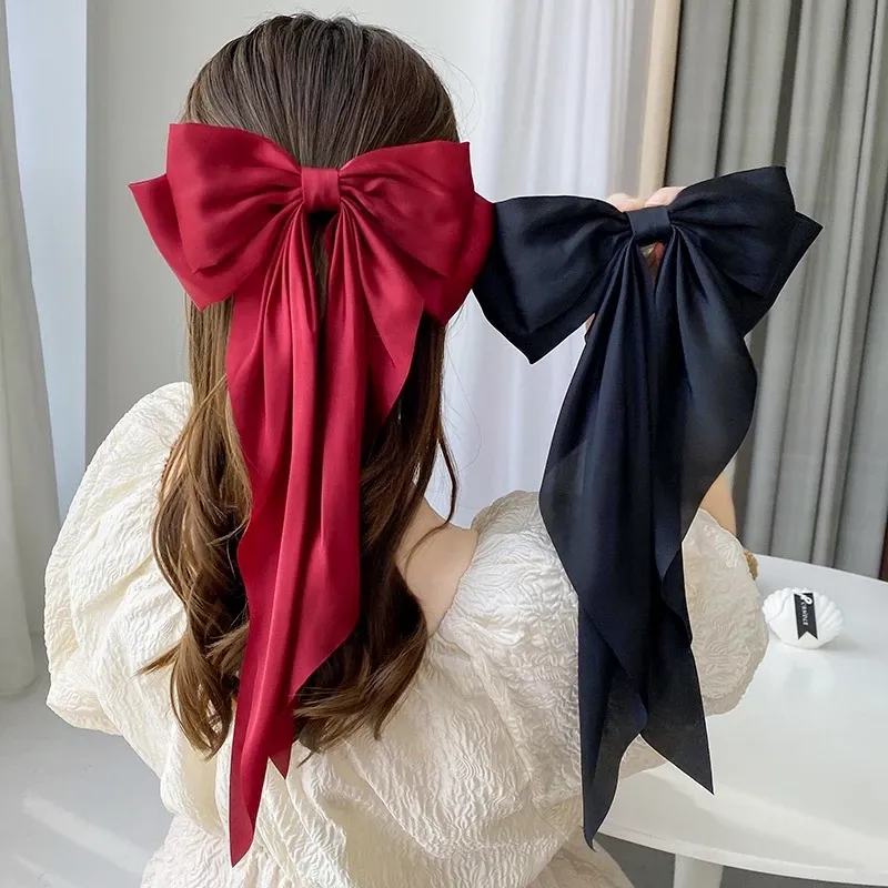 Oversized Satin Bow Hair Clip adds an elegant, feminine finish to everyday hairstyles in seconds. The flowing long-tail design looks beautiful with ponytails, half-up styles, curls and more.