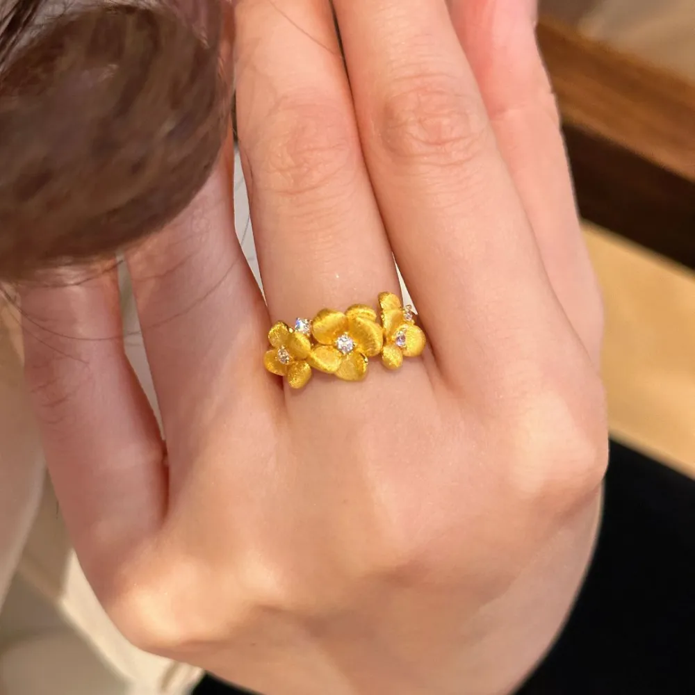 The Golden Blossom Ring turns delicate flowers into an eye-catching piece of jewelry.  Its textured petals catch the light beautifully, while sparkling crystal accents add just enough shine without feeling overdone.  Perfect with dresses, everyday outfits