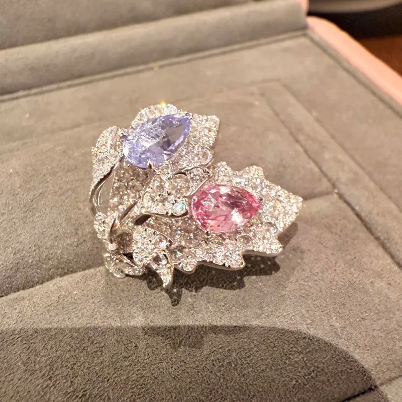 ✨ The kind of ring people can’t stop staring at. A dreamy mix of pink & lavender sparkle wrapped in an elegant leaf-inspired design. 💗💜