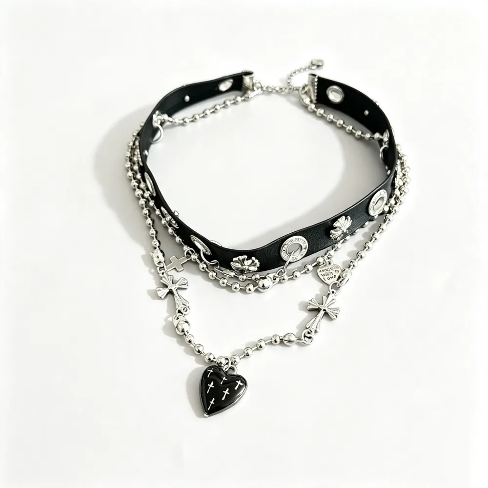 Cute? Dark? A little dangerous? 🖤  Why choose one?  This layered choker mixes edgy silver-tone chains with delicate bows, crosses and a black heart centerpiece—giving you that perfect dark feminine aesthetic.