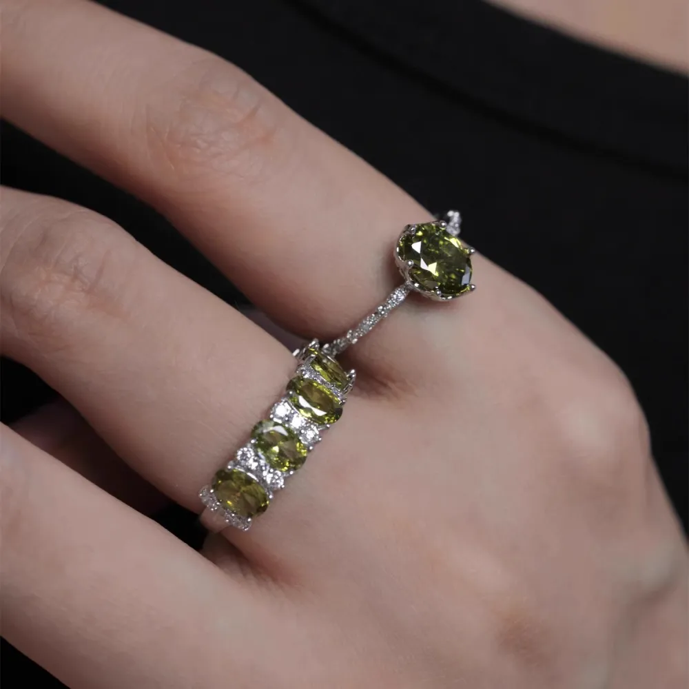 ✨ A little sparkle. A lot of elegance. The rich olive-green stones paired with a delicate silver-tone setting create a look that feels effortlessly luxurious.  Wear it alone for a refined touch or stack your favorites for extra sparkle. 💚
