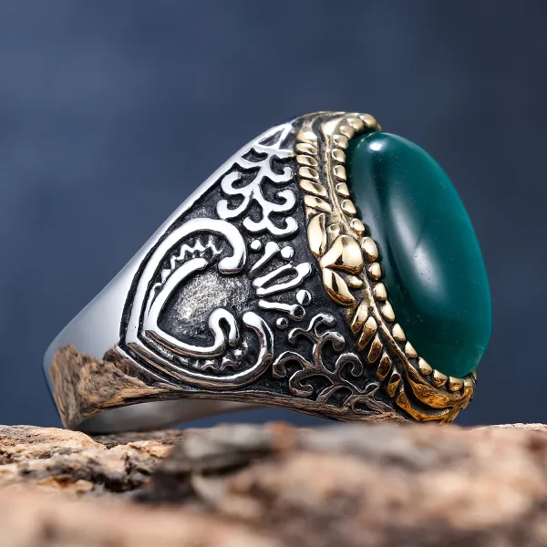 💚 A Ring That Commands Attention.  Deep green cat-eye style stone, intricate vintage detailing, and a striking silver & gold-tone finish — this statement ring brings timeless character to every look.  Perfect for men who prefer bold accessories with a cl