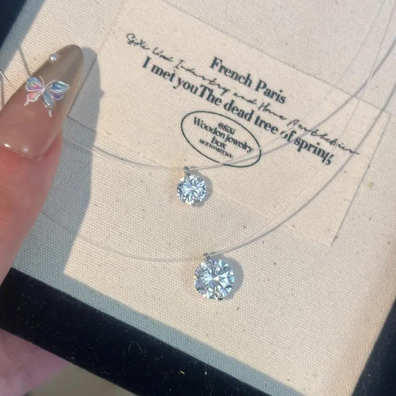 ✨ It looks like it’s floating on your skin. A barely-there clear necklace paired with a sparkling solitaire pendant creates the perfect minimalist look. Delicate, elegant, and effortless enough to wear every day. 💎  Wear it alone for a clean look or laye
