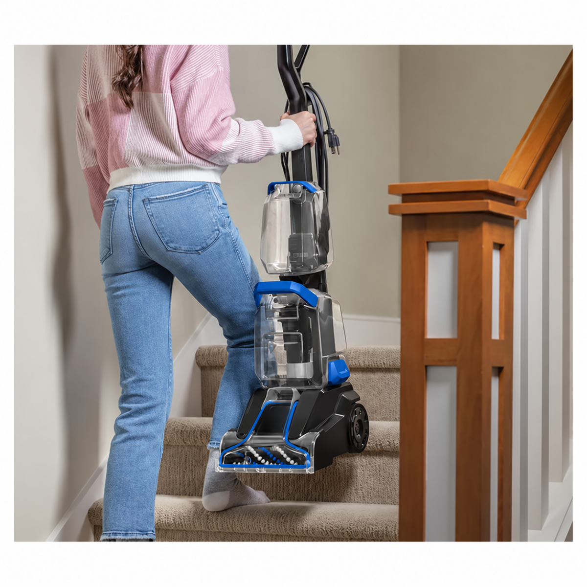 Cleaner being carried on carpeted stairs