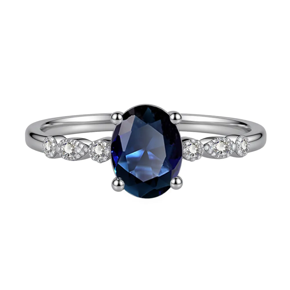 Elegant, delicate, and effortlessly beautiful. This oval gemstone ring features a brilliant faceted center stone surrounded by sparkling accents for a timeless, feminine look.