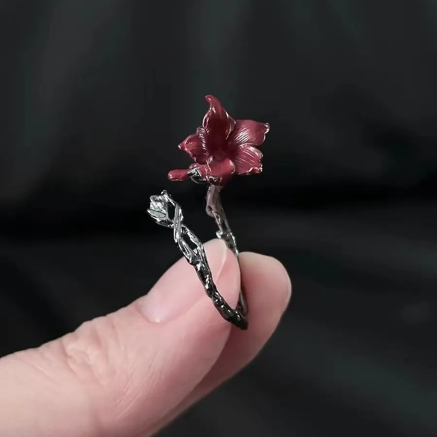 🌹 A Rose That Never Fades.  Dark, romantic, and beautifully unexpected. This vintage-inspired floral ring wraps around your finger like a tiny blooming vine, finished with a deep red flower that instantly catches the eye.