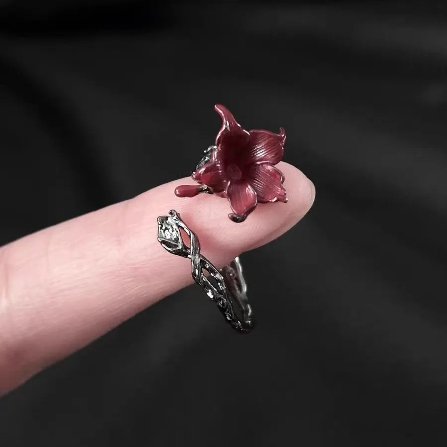 🌹 A Rose That Never Fades.  Dark, romantic, and beautifully unexpected. This vintage-inspired floral ring wraps around your finger like a tiny blooming vine, finished with a deep red flower that instantly catches the eye.