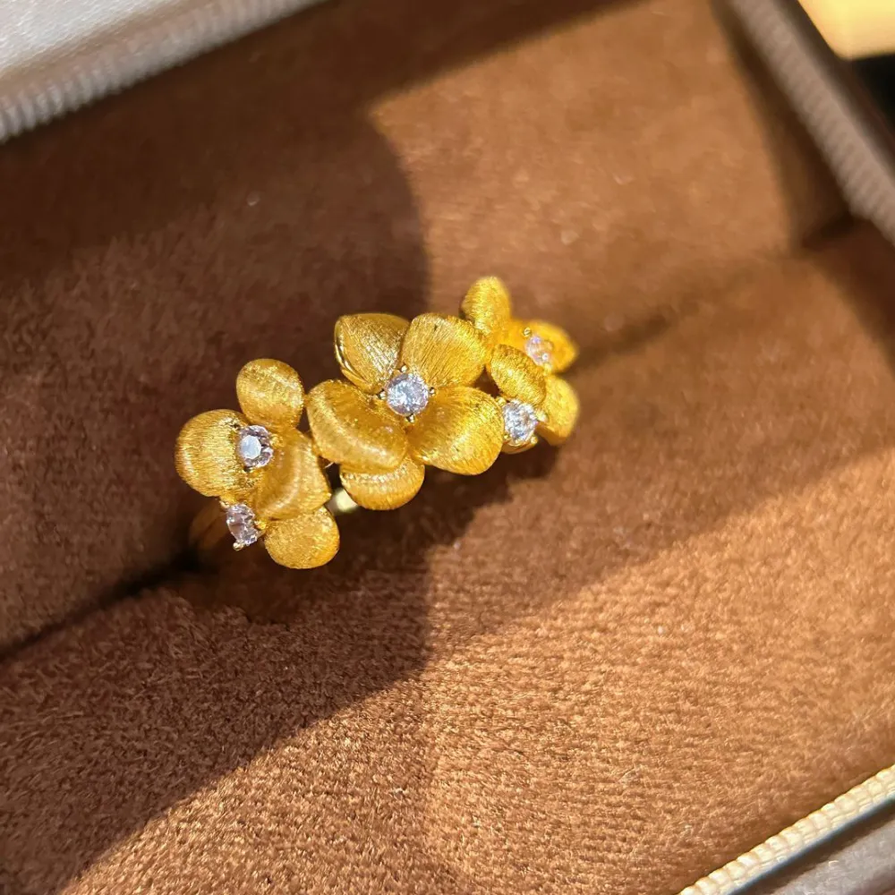The Golden Blossom Ring turns delicate flowers into an eye-catching piece of jewelry.  Its textured petals catch the light beautifully, while sparkling crystal accents add just enough shine without feeling overdone.  Perfect with dresses, everyday outfits