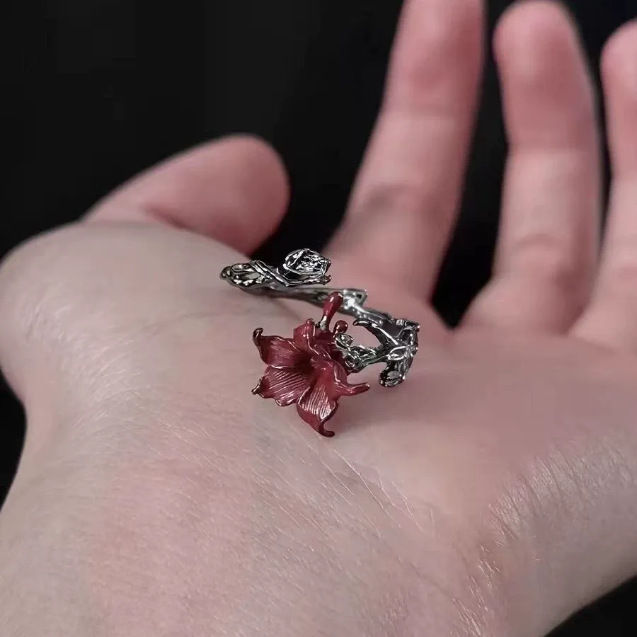 🌹 A Rose That Never Fades.  Dark, romantic, and beautifully unexpected. This vintage-inspired floral ring wraps around your finger like a tiny blooming vine, finished with a deep red flower that instantly catches the eye.