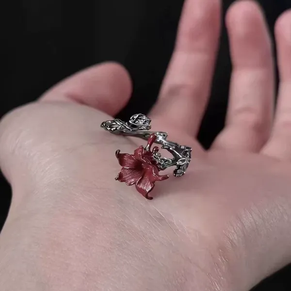 🌹 A Rose That Never Fades.  Dark, romantic, and beautifully unexpected. This vintage-inspired floral ring wraps around your finger like a tiny blooming vine, finished with a deep red flower that instantly catches the eye.