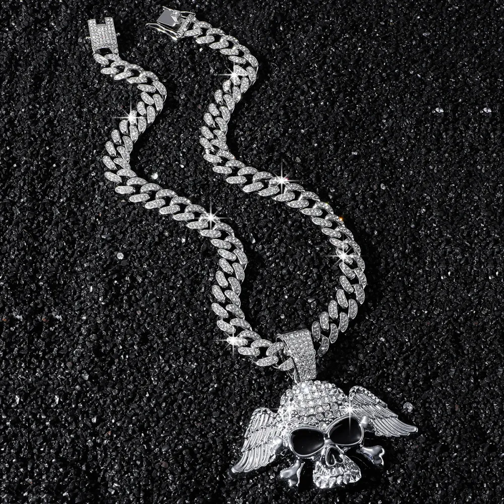 💀 NOT MADE TO BLEND IN. 🔥  Turn heads the second you walk in.  This iced-out Cuban chain features a bold winged skull pendant, packed with eye-catching shine and serious street attitude. Whether you choose Gold or Silver, this piece instantly upgrades y