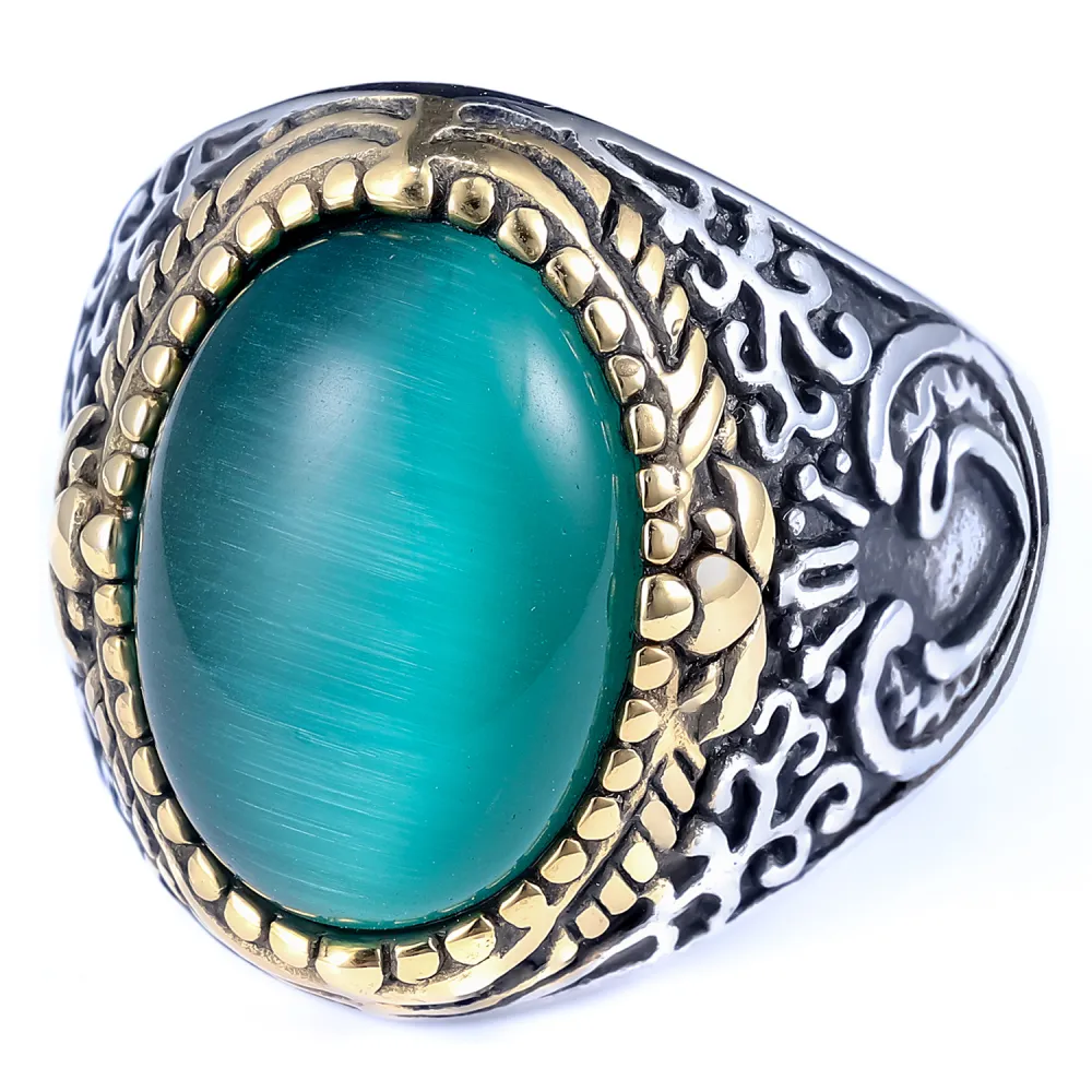 💚 A Ring That Commands Attention.  Deep green cat-eye style stone, intricate vintage detailing, and a striking silver & gold-tone finish — this statement ring brings timeless character to every look.  Perfect for men who prefer bold accessories with a cl