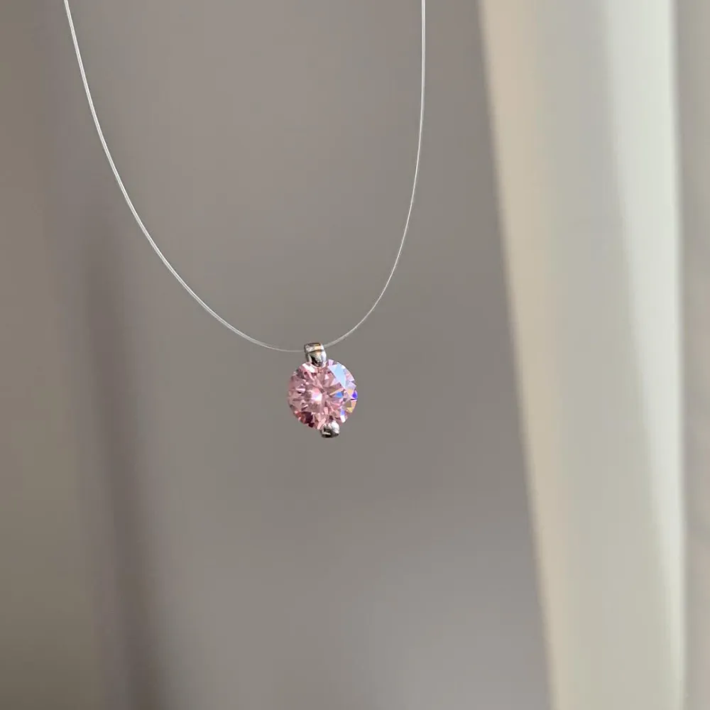 ✨ It looks like it’s floating on your skin. A barely-there clear necklace paired with a sparkling solitaire pendant creates the perfect minimalist look. Delicate, elegant, and effortless enough to wear every day. 💎  Wear it alone for a clean look or laye