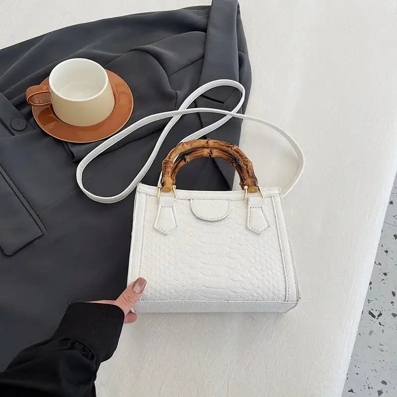 Artisanal Detail: Textured Bamboo-Handle Structured Bag
