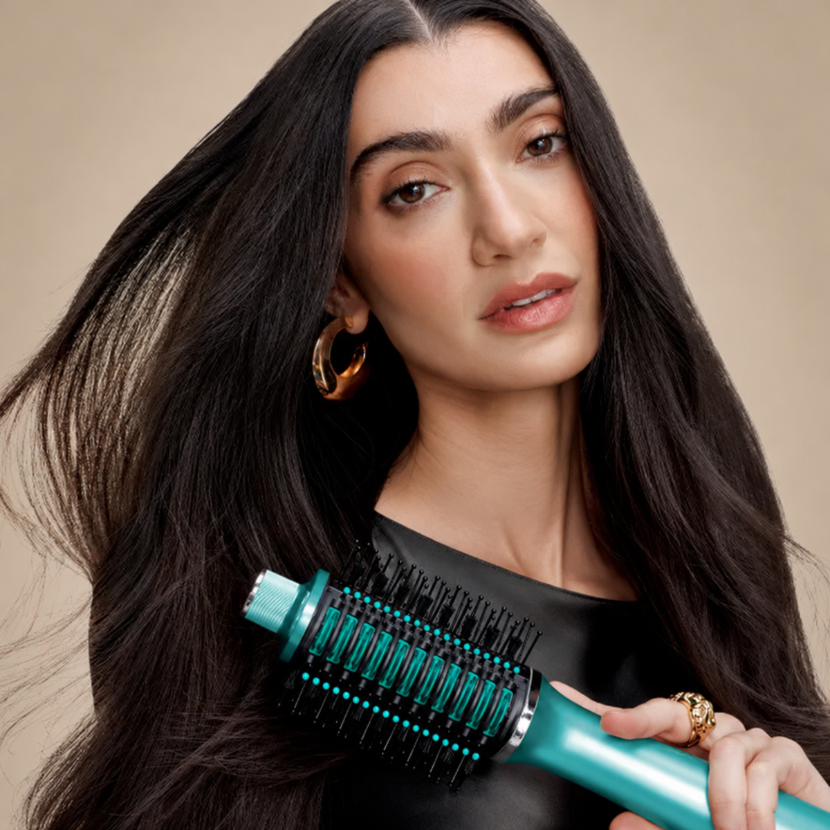 A person holding the styling brush