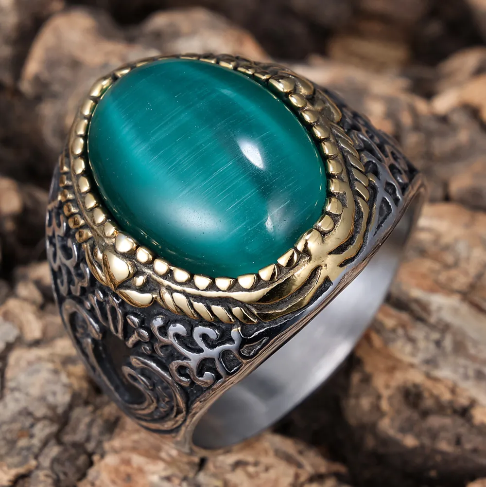 💚 A Ring That Commands Attention.  Deep green cat-eye style stone, intricate vintage detailing, and a striking silver & gold-tone finish — this statement ring brings timeless character to every look.  Perfect for men who prefer bold accessories with a cl