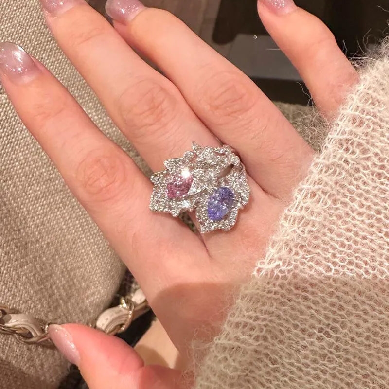 ✨ The kind of ring people can’t stop staring at. A dreamy mix of pink & lavender sparkle wrapped in an elegant leaf-inspired design. 💗💜