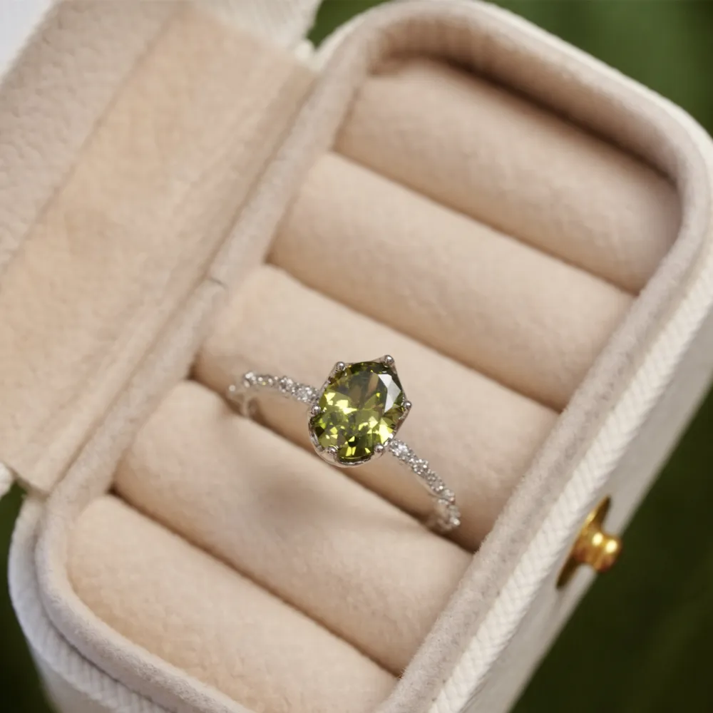 ✨ A little sparkle. A lot of elegance. The rich olive-green stones paired with a delicate silver-tone setting create a look that feels effortlessly luxurious.  Wear it alone for a refined touch or stack your favorites for extra sparkle. 💚