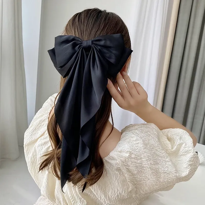 Oversized Satin Bow Hair Clip adds an elegant, feminine finish to everyday hairstyles in seconds. The flowing long-tail design looks beautiful with ponytails, half-up styles, curls and more.