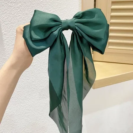 Oversized Satin Bow Hair Clip adds an elegant, feminine finish to everyday hairstyles in seconds. The flowing long-tail design looks beautiful with ponytails, half-up styles, curls and more.